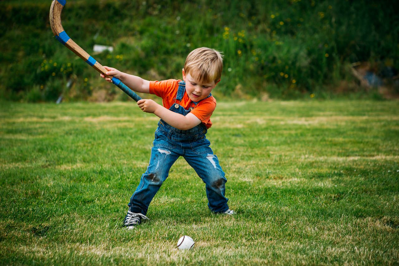 young boy playing shinty Skye