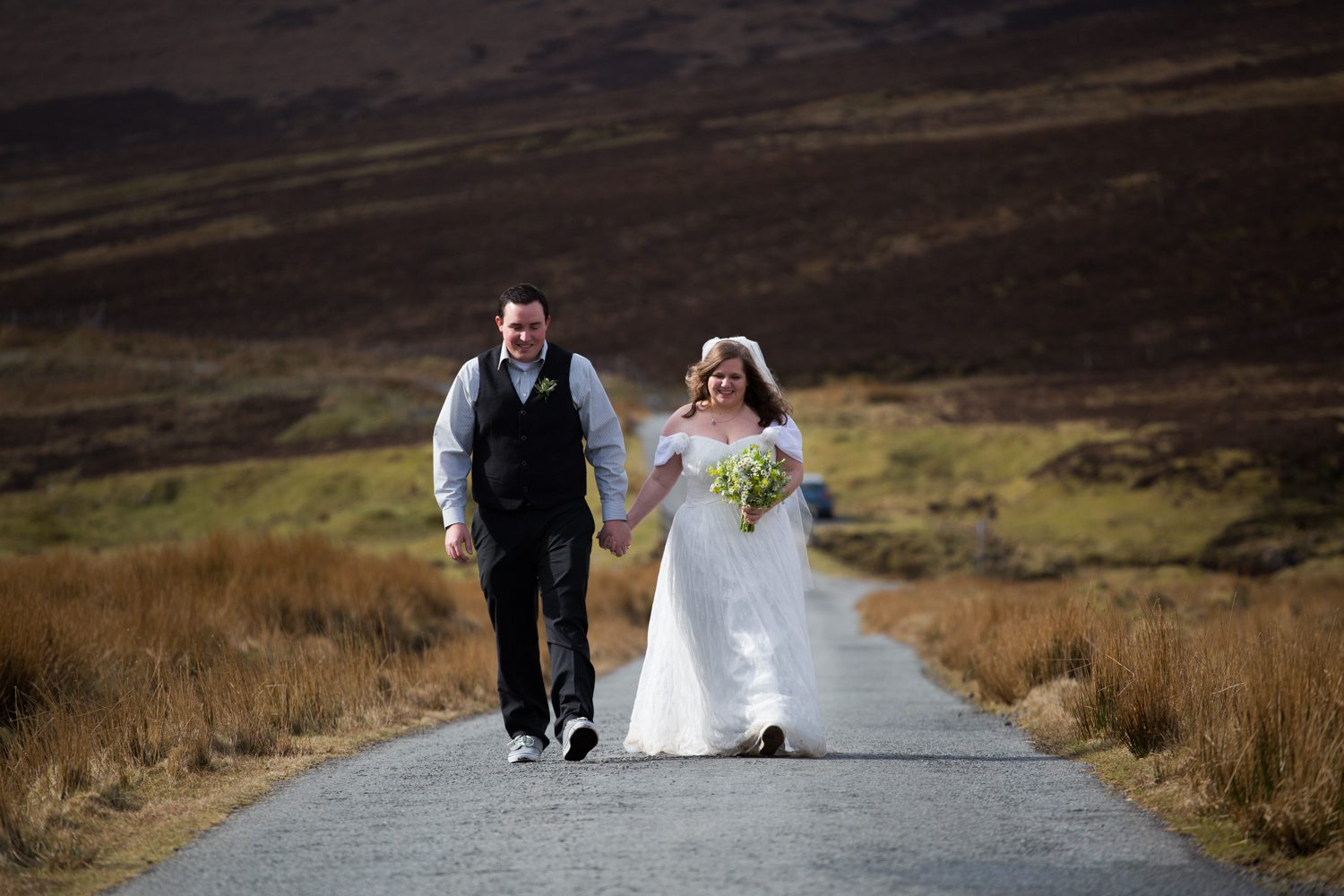 Walking the moor road from the Fairy Glen to the Quiraing, Isle of Skye on their wedding day
