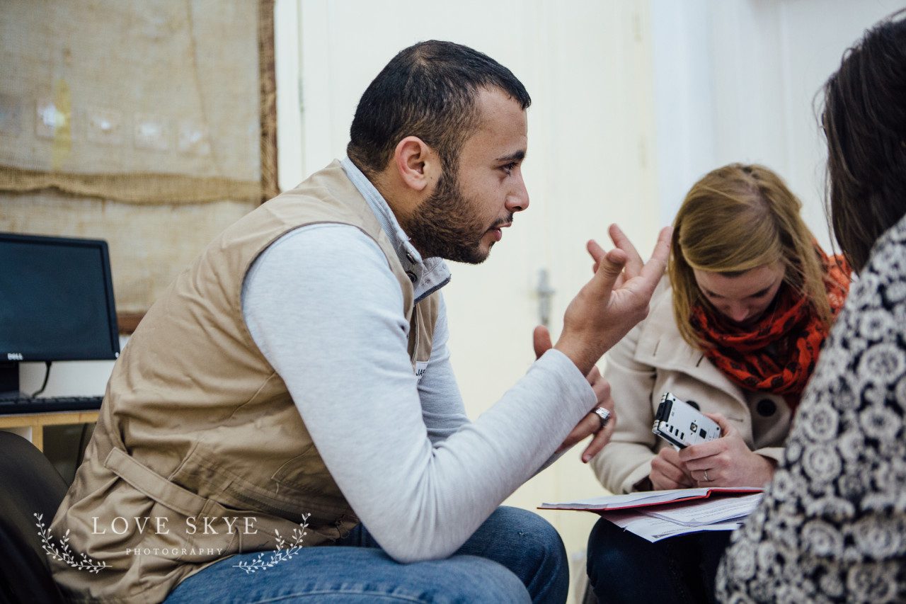 World Vision project teacher discusses remedial school in Jordan for Syrian refugees with two female journalists Iribid north of Amman