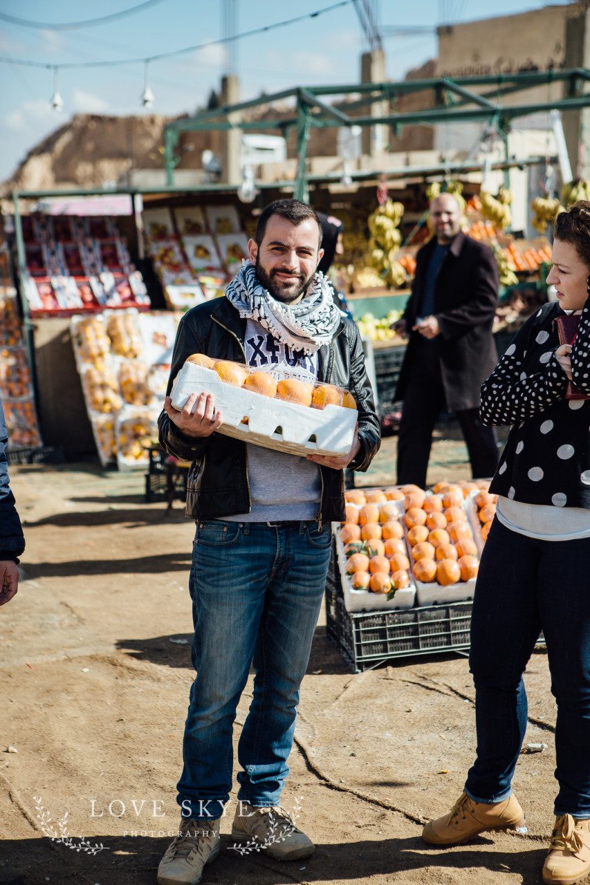 World Vision staff buy fruit to take to children in Azraq camp Jordan