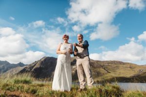 Groom and bride opening champagne Isle of Skye