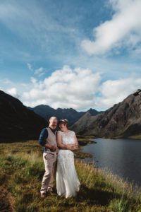 Bride and groom cuddling for photographs at Loch Coruisk