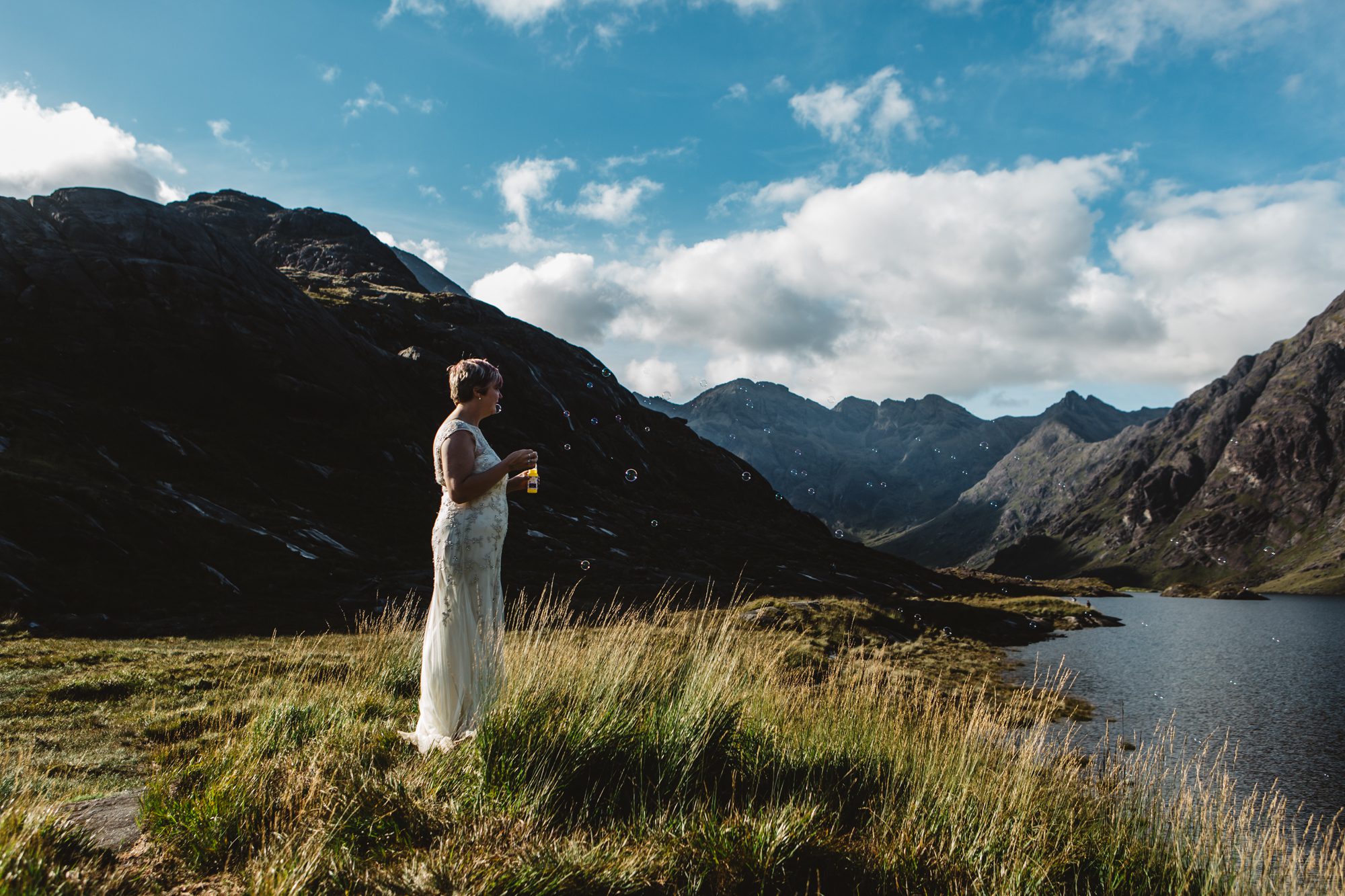 Backlit bride surrounded by bubbles at Loch Coruisk
