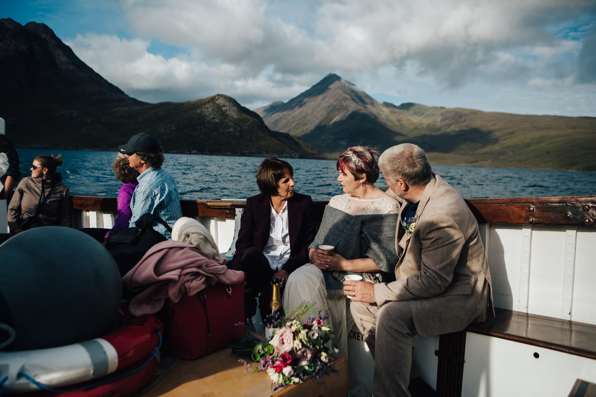 Bride and Groom chatting aboard Misty Isle boat , Sgurr na Stri behind