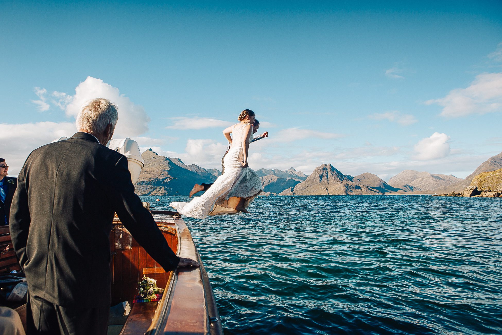 Bride and Groom aboard Misty Isle Loch Coruisk Elopement jumping into sea