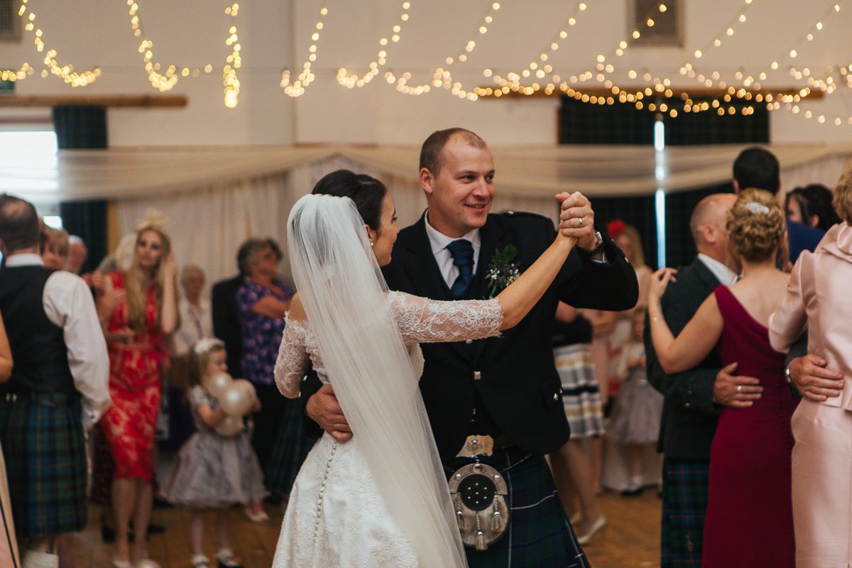 Bride and groom first dance village hall fairy lights Uist wedding photography