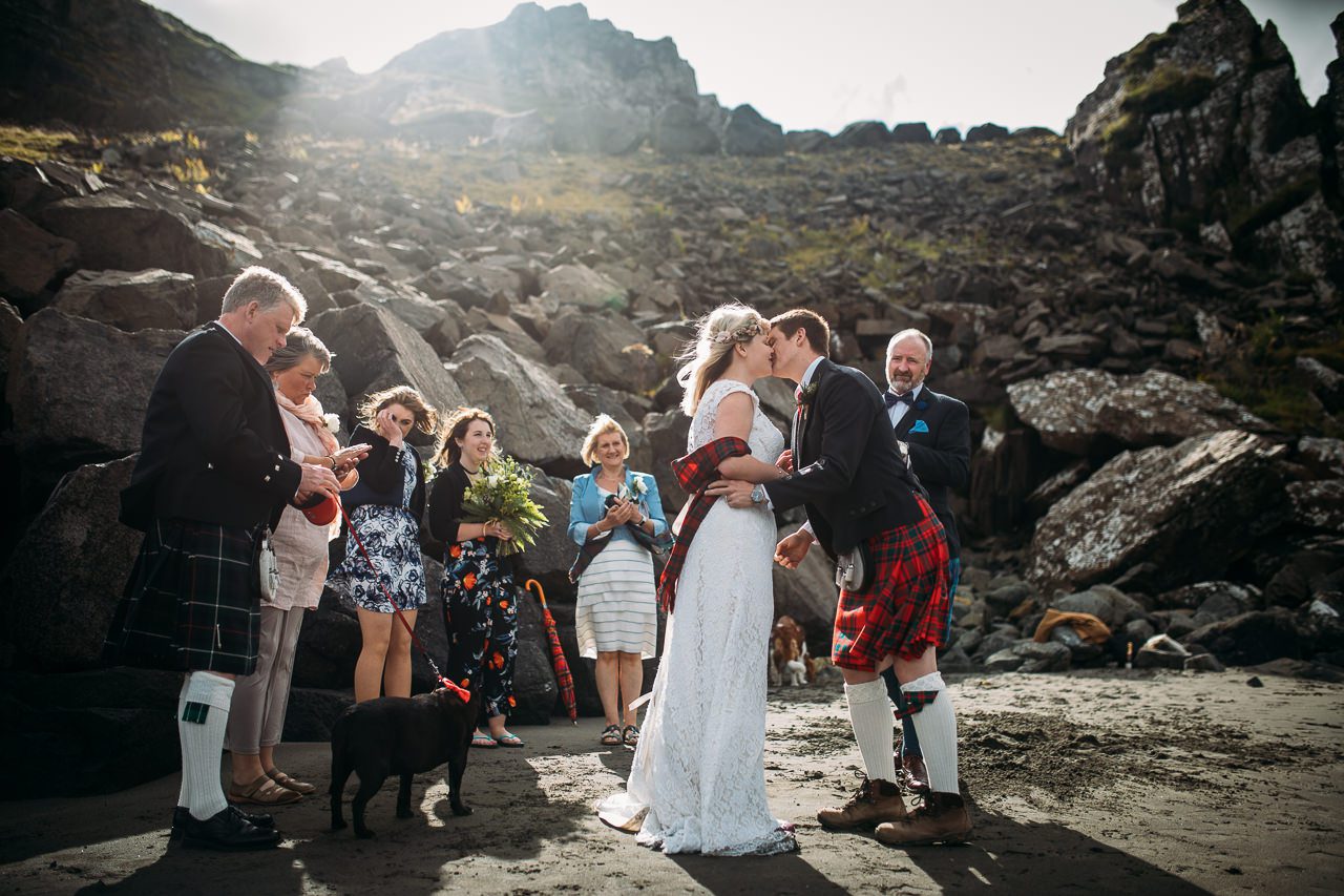 first kiss bride and kilted groom Staffin beach Isle of Skye