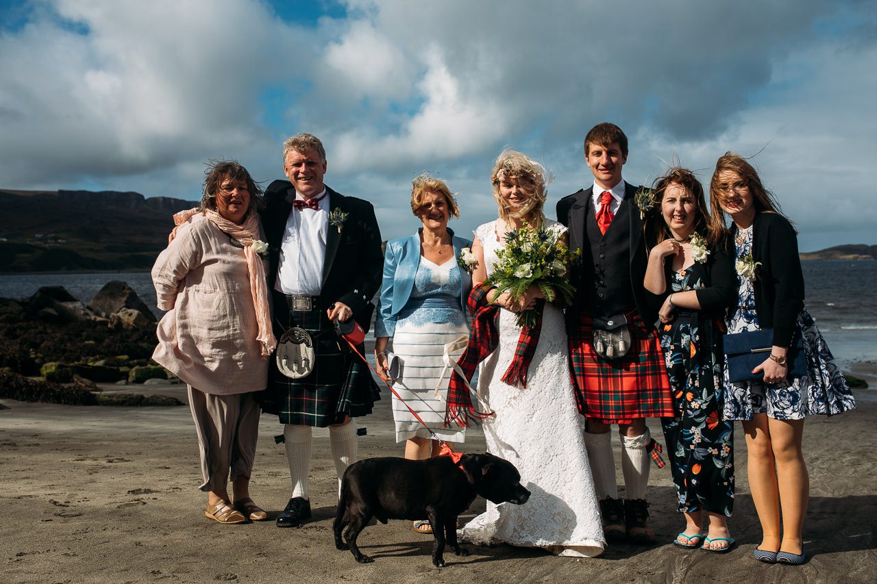 Wedding family photo on beach with pet dog Staffin Isle of Skye
