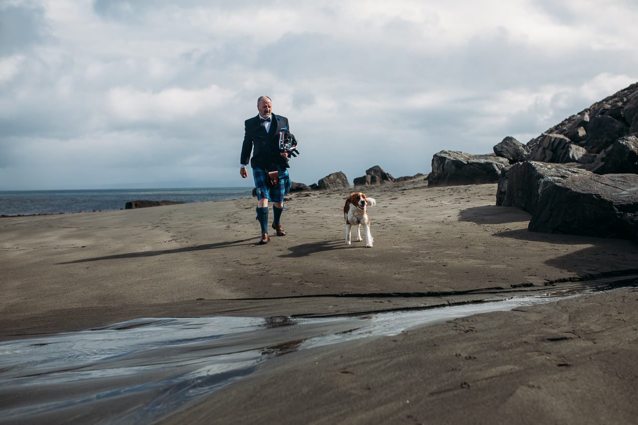 Humanist celebrant Neil Lynch and dog arrive for wedding Staffin beach Isle of Skye