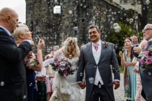 Bubbles exit Eilean Donan Castle wedding