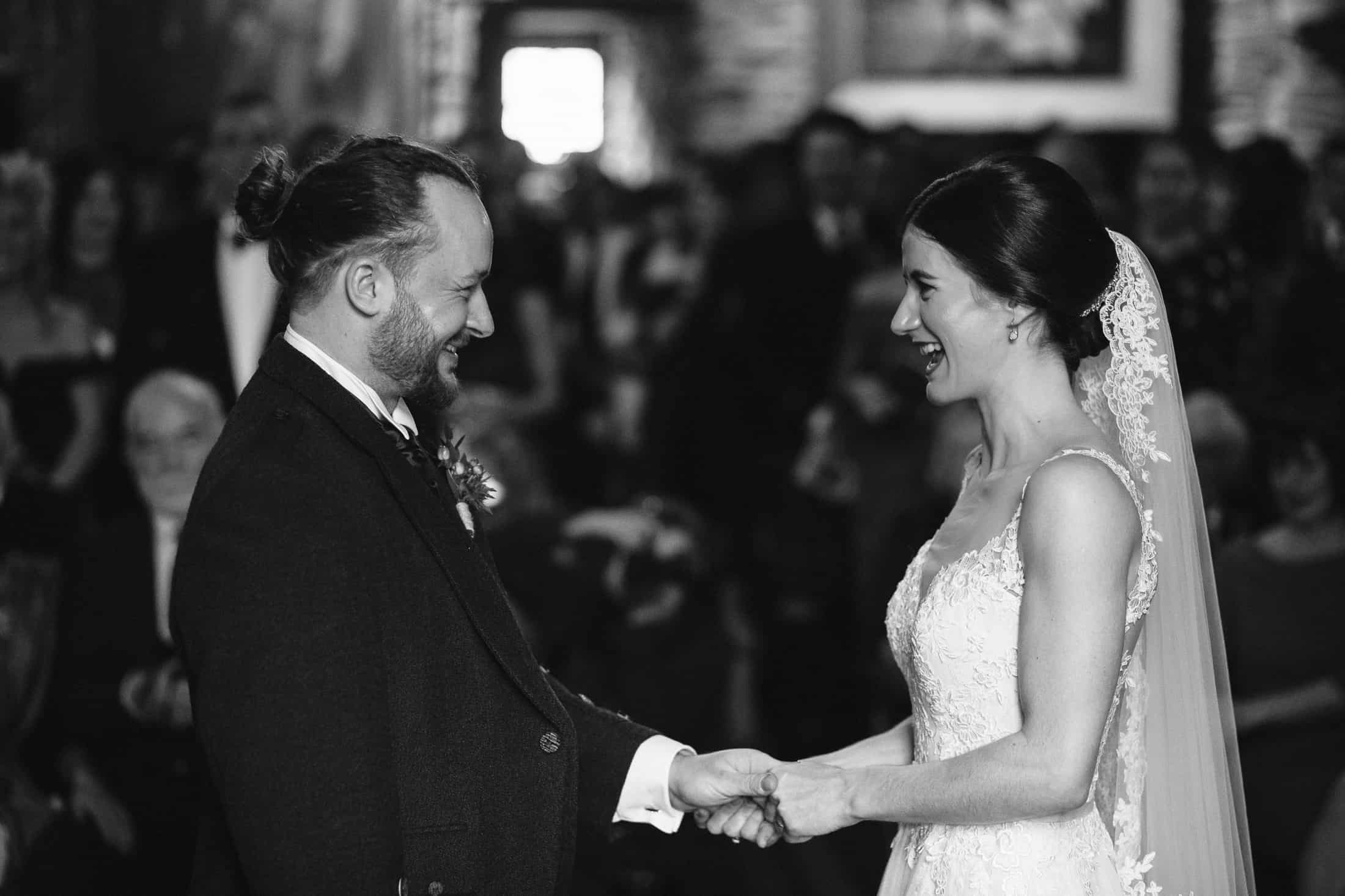 Black and white image bride during wedding ceremony Eilean Donan Castle