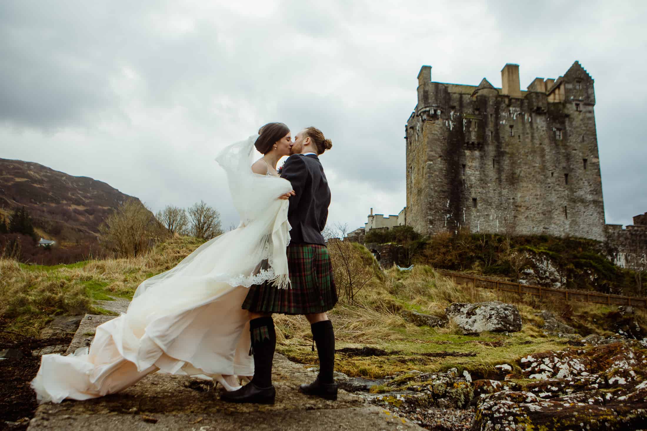 Bride and groom kiss courtyard Eilean Donan Castle wedding photography
