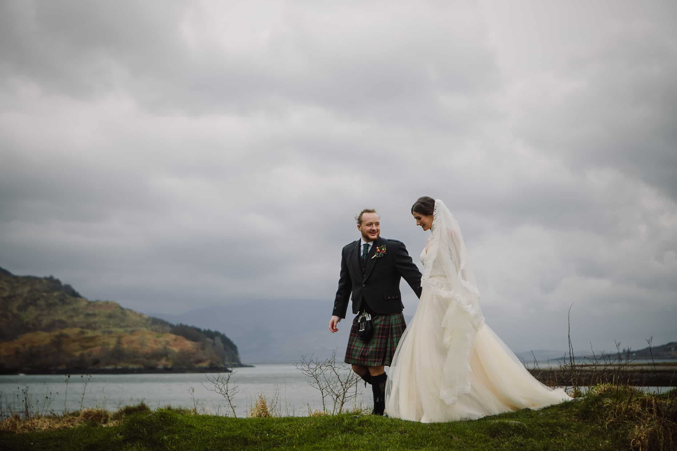 bride and groom moody sky Eilean Donan Castle