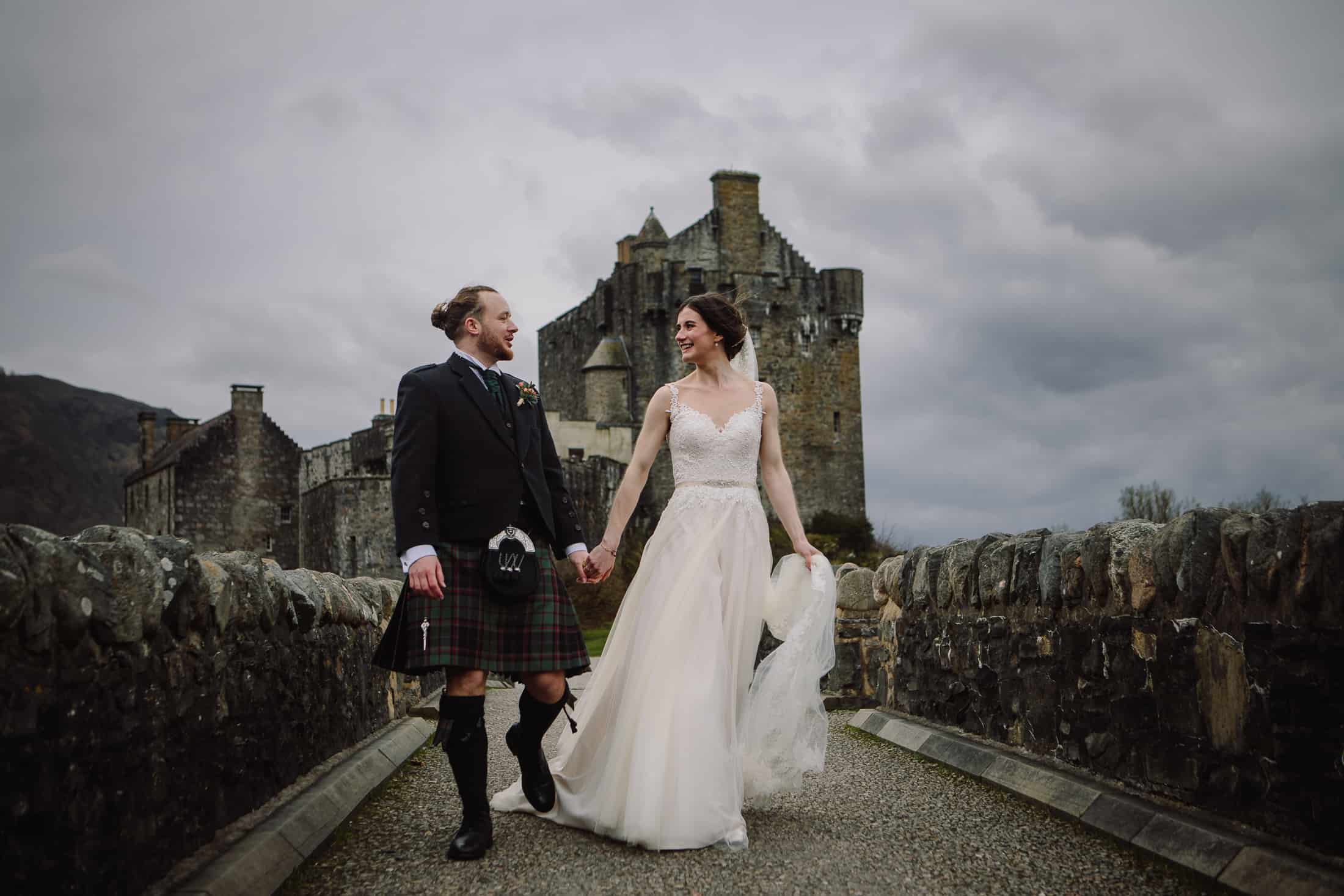 Bride and groom on bridge Eilean Donan Castle