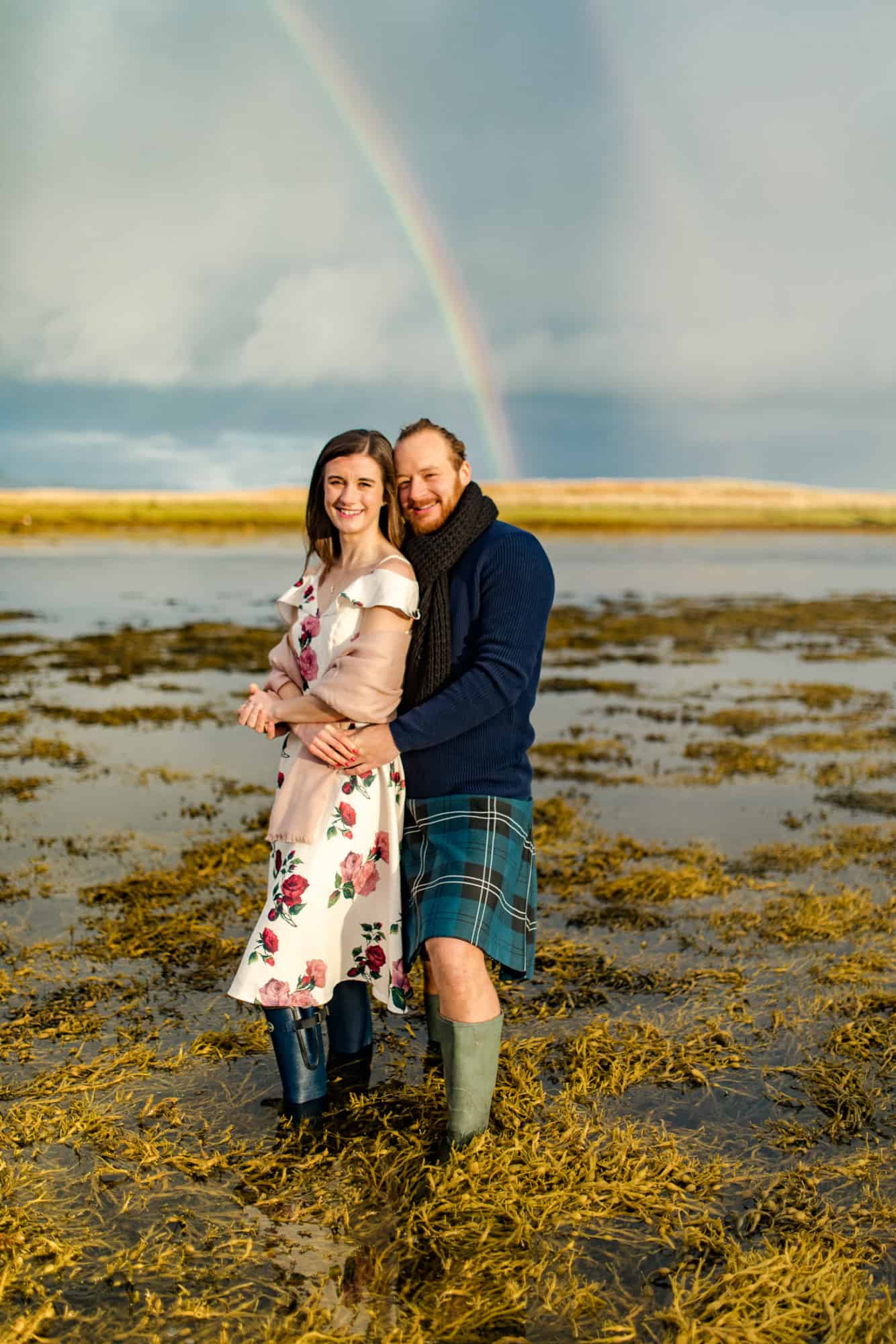 Isle of Skye enagement photoshoot. Couple in sea with rainbow