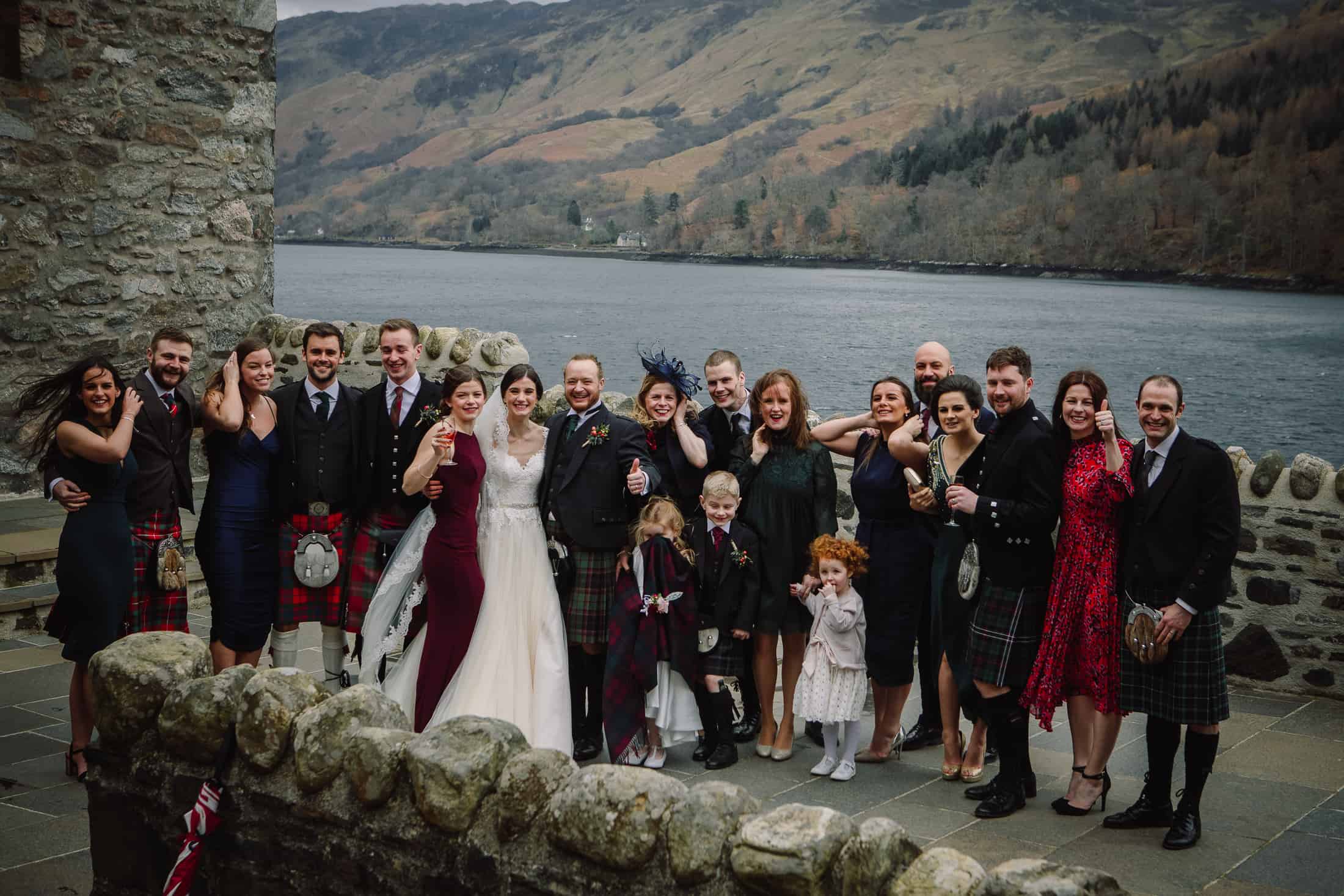 Group photo wedding guests Eilean Donan Castle