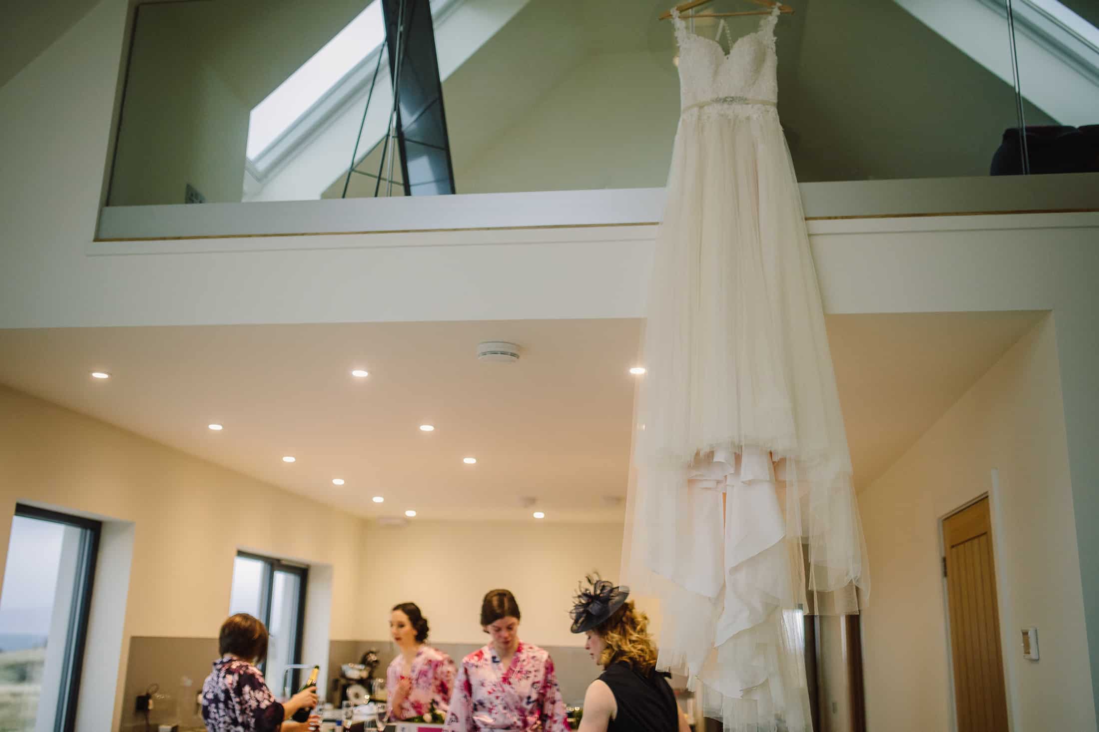 Wedding dress hanging on balcony during wedding prep Isle of Skye