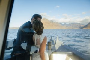 wedding couple kiss on misty isle boat