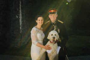 Bride and groom with dog at Eilean Donan Castle