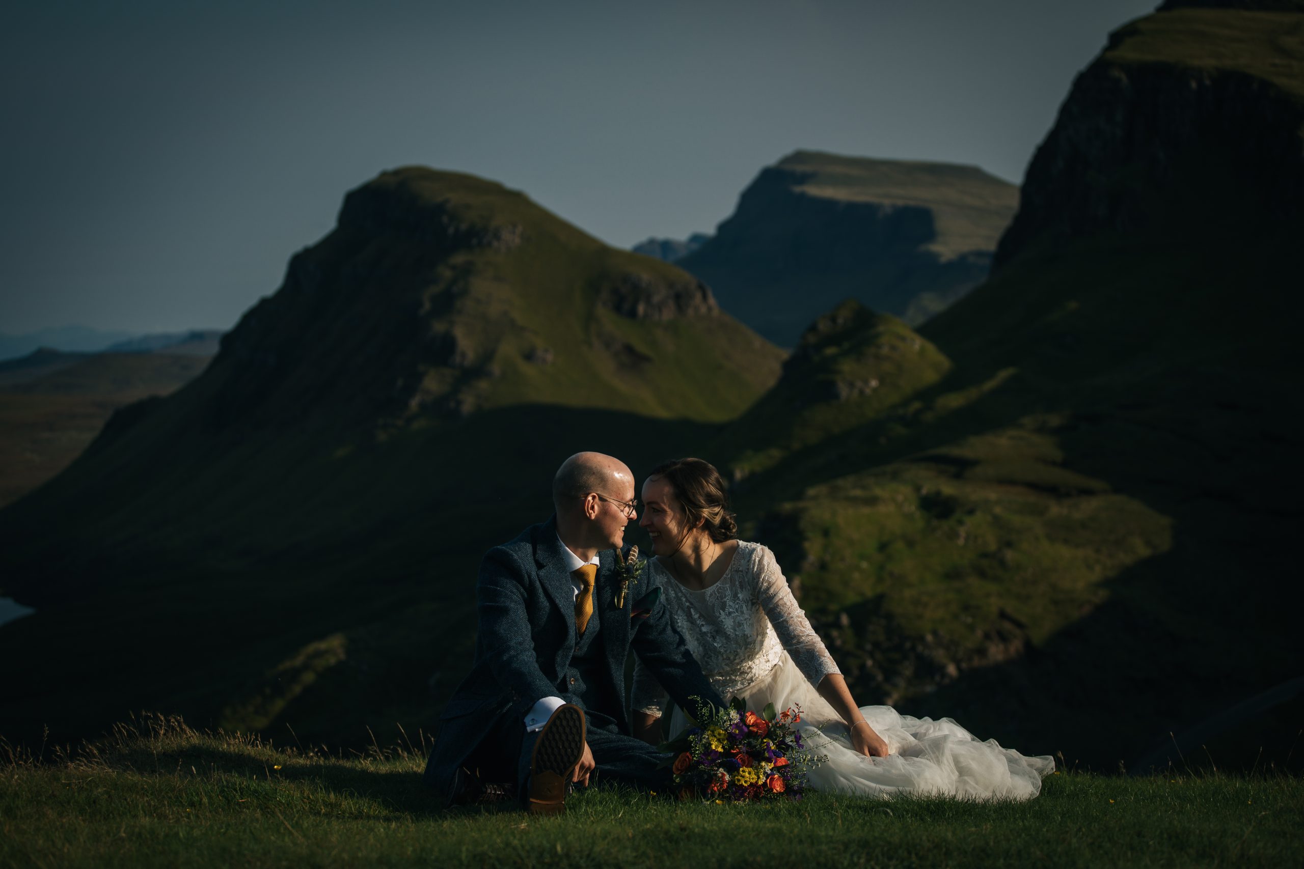 Bride and Groom at Quiraing, Isle of Skye in summer. Green hills

