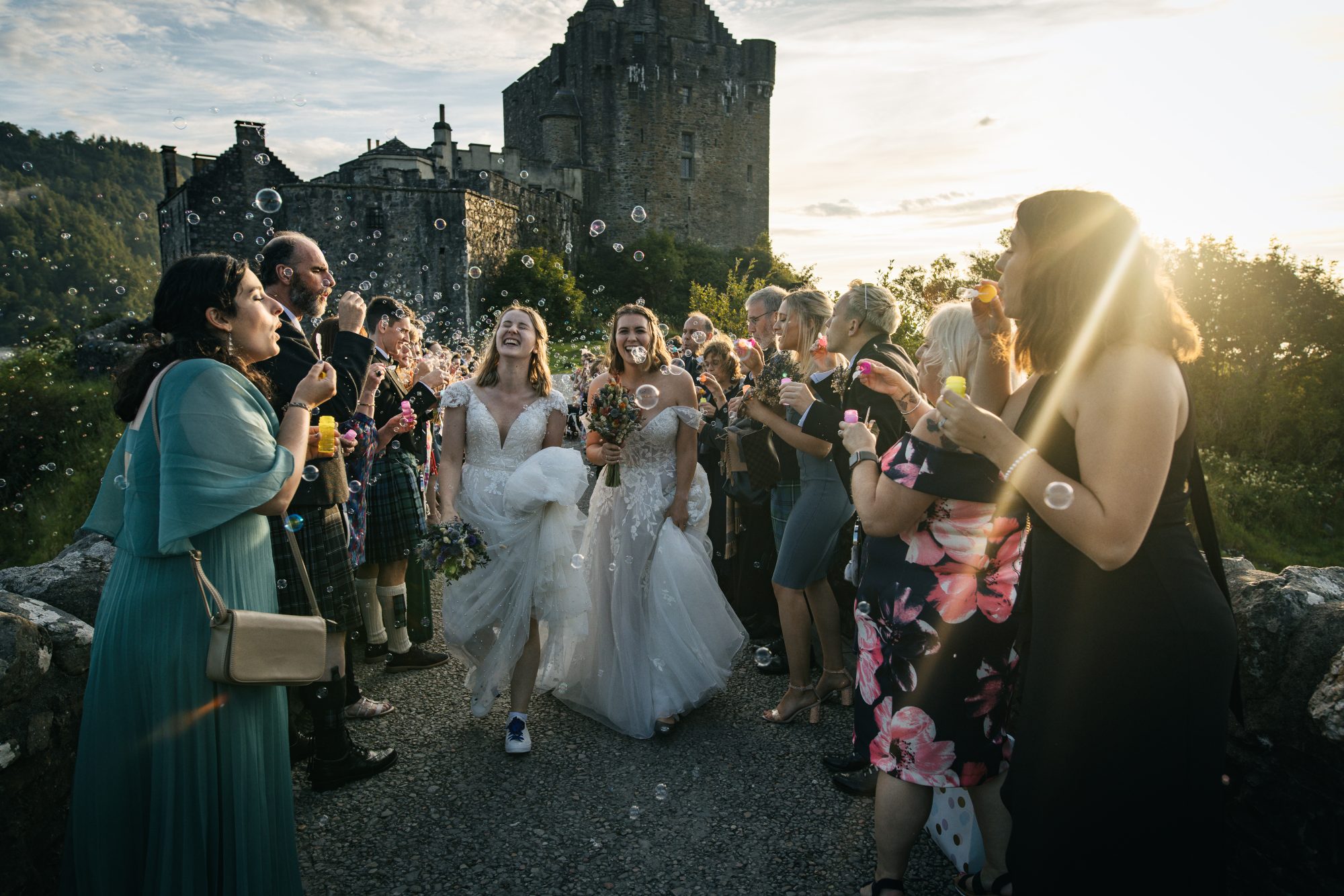 two brides leaving Eilean donan Castle with a bubble exit